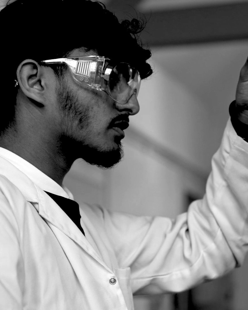 Sixth-former in safety goggles during a science lesson